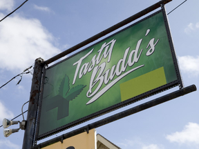 A green rectangle covers the words "medical dispensary" on the Tasty Budd's street sign, which is operating as a compassion club, on Wharncliffe Road in London, Ont. on Thursday August 25, 2016. Craig Glover/The London Free Press/Postmedia Network