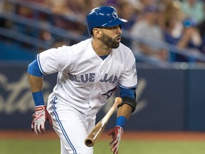 Toronto Blue Jays' Jose Bautista hits a sacrifice fly to score a run against the Los Angeles Angels during a game in Toronto on Aug. 25, 2016. (THE CANADIAN PRESS/Fred Thornhill)