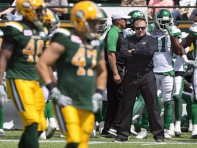 Saskatchewan Roughriders head coach Chris Jones watches as the Edmonton Eskimos line up during first half CFL pre-season action in Edmonton, Alta., on June 18, 2016.  THE CANADIAN PRESS/Jason Franson