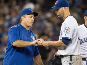 Toronto Blue Jays manager John Gibbons takes the ball from starting pitcher J.A. Happ during the sixth inning of a game against the Los Angeles Angels in Toronto on Aug. 25, 2016. (THE CANADIAN PRESS/Fred Thornhill)