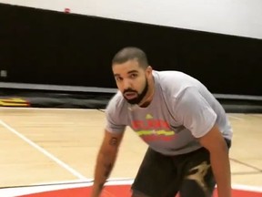 Drake after draining a half-court shot while lying on the ground (Instagram screen grab)