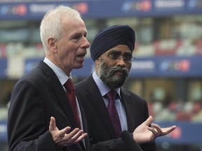 Defence Minister Harjit Sajjan listens as Foreign Affairs Minister Stephane Dion responds to a question during an interview at the NATO summit in Warsaw, Poland, on July 9, 2016. (THE CANADIAN PRESS/Adrian Wyld)