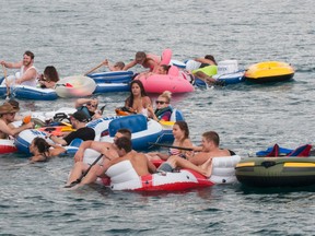 Floaters travel down the St. Clair River during Float Down at Lighthouse Beach in Port Huron, Mich., Sunday, Aug. 21, 2016. Thousands of people gathered for the event and floated down the St. Clair River. (Mark R. Rummel/The Times Herald via AP)