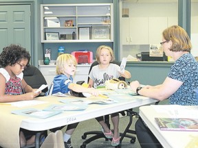 A group of young students solve riddles about animals during the Organization for Literacy in Lambton's annual summer day camp. (Carl Hnatyshyn/Postmedia Network)