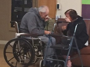 In this Monday, Aug. 22, 2016 photo provided by Ashley Bartyik, her grandparents Wolfram and Anita Gottschalk of Surrey, British Columbia, Canada, cry as they say goodbye near the end of a visit with each other in Wolfram's elderly care home in Surrey. (Ashley Bartyik via AP)