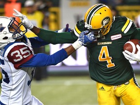 Eskimos' Adarius Bowman (right) gets face-masked by Alouettes defender Greg Henderson (left) who received a penalty during CFL action in Edmonton on Aug. 11, 2016. (Ed Kaiser/Postmedia Network)