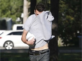 Maciej Andrej Szczypka hides his face as he leaves the Ottawa-Carleton Detention Centre on Tuesday, Aug. 5, 2015. PATRICK DOYLE / THE OTTAWA CITIZEN