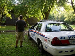 The owner of the property talks to a police officer guarding the scene, after an overnight fire on Trafalgar St. near Bancroft Road in London, Ont. on Friday August 26, 2016. The owner of the property said that the house was due to be demolished anyway shortly. The owner said he checked the property daily and kept the building secured. (MIKE HENSEN, The London Free Press)