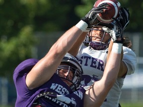 Chris Bunting, front, attempts to pick off a pass intended for Justin Sanvido during Western Mustangs football practice at TD Stadium on Friday. (CRAIG GLOVER, The London Free Press)