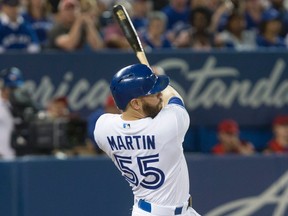 Toronto Blue Jays' Russell Martin hits a three-run double against the Minnesota Twins in Toronto on Aug. 26, 2016. (THE CANADIAN PRESS/Chris Young)