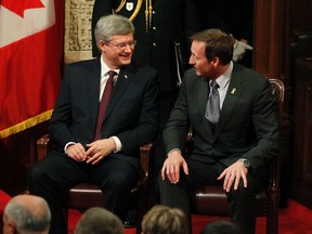 Prime Minister Stephen Harper (left) and Minister of Defence Peter MacKay (right) talk to one another during the ceremony marking the successful completion of Operation Mobile, the UN-sanctioned NATO mission to protect Libyan civilians, in Ottawa November 24, 2011. (Postmedia Network files)