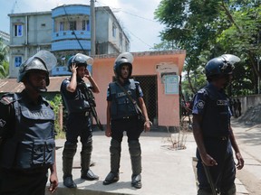 Bangladesh policemen cordon off the area near a two-storey house, behind in blue, that they raided in Narayanganj district near Dhaka, Bangladesh, Saturday, Aug. 27, 2016. Police in Bangladesh killed three suspected militants Saturday, including an alleged mastermind of a major attack on a cafe last month that left 20 people dead. (AP Photo)