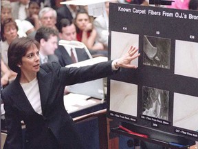Lead prosecutor Marcia Clark (L) points to a magnified fibre from O.J. Simpson's Ford Bronco as FBI Hair and fibre expert Douglas Deedrick (R) testifies that the fibre found on the Rockingham glove (below) could have come from Mr. Simpson's Ford Bronco during the O.J. Simpson murder trial in Los Angeles.   (POOL/AFP/Getty Images File Photo)