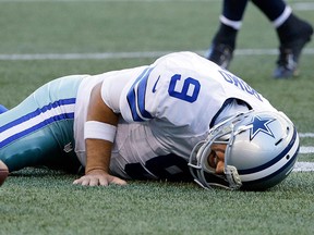 Dallas Cowboys quarterback Tony Romo lies on the turf after he went down on a play against the Seattle Seahawks during the first half of a preseason NFL football game, Thursday, Aug. 25, 2016, in Seattle. (AP Photo/Elaine Thompson)