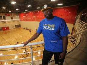 Donovan Gayle stands at the University of Winnipeg above a game being played at the Ballin for a Cure basketball tournament, which he organized in 2014 to raise funds for cancer research. Gayle, a Leukemia survivor, said 14 teams registered to take part, many of them made up of players he once competed with and against at Brandon University. (Sun/Postmedia Network)