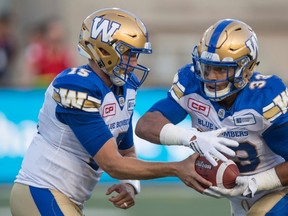 Winnipeg Blue Bombers quarterback Matt Nichols hands off to running back Andrew Harris as they face the Montreal Alouettes during first quarter CFL football action Friday, August 26, 2016 in Montreal. THE CANADIAN PRESS/Paul Chiasson