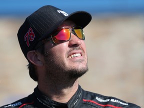 Martin Truex Jr, driver of the #78 Furniture Row/Denver Mattress Toyota, stands on the grid during qualifying for the NASCAR Sprint Cup Series Pure Michigan 400 at Michigan International Speedway on August 26, 2016 in Brooklyn, Michigan.  (Photo by Jerry Markland/Getty Images)