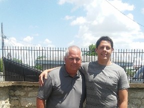 In this May 30, 2016 photo, Gregory Beckman and his son, Marcus, visit the grave site of their relative Augustus Beckmann at Camp Chase Confederate Cemetery on Memorial Day weekend. The name and information on the stone is incorrect. Due to Beckman's efforts in tracking down his family history and noting that the stone is wrong, a national cemetery association will fix it. (Ted Decker/The Columbus Dispatch via AP)