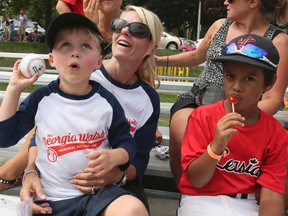 Jillian Walsh watches baseball with her son Flinn, 4,who sits on her lap at the 2nd annual Georgia Walsh Memorial All-Star Games on Friday August 26, 2016. Veronica Henri/Toronto Sun/Postmedia Network