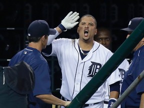 Detroit Tigers' Victor Martinez continues to yell at home plate umpire Mike Everitt following his ejection as manager Brad Ausmus, left, watches during the third inning of a baseball game against the Los Angeles Angels on Saturday, Aug. 27, 2016, in Detroit. (AP Photo/Duane Burleson)