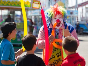 Doo Doo the Clown entertains the kids with balloons at the Capital Fair.