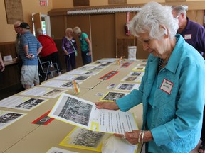 Marian-Ann Whitfield, from London, looks at one of the class photographs on display at the Salford Community Centre on Aug. 27, 2016. Hundreds gathered for a reunion of the area's three former schools. (MEGAN STACEY/Sentinel-Review)