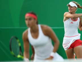 Caroline Garcia and Kristina Mladenovic of France in their doubles match against Misaki Doi and Eri Hozumi of Japan on Day 1 of the Rio 2016 Olympic Games at the Olympic Tennis Centre on Aug. 6, 2016 in Rio de Janeiro, Brazil.  (Photo by Julian Finney/Getty Images)
