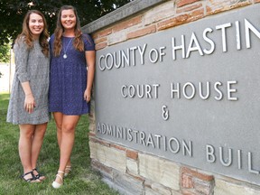Maddison Ellis (left) and Sarah McCurdy stand beside the Hastings County sign outside of the administration building they've spent their summers working in on Friday August 26, 2016 in Belleville, Ont. Summer job opportunities are an attempt by the county to get more youth involved in local government. Tim Miller/Belleville Intelligencer/Postmedia Network