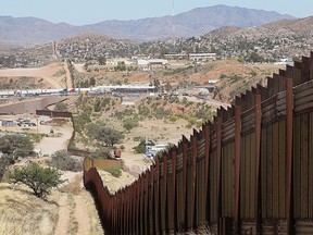 A fence separates the cities of Nogales, Ariz. (L) and Nogales, Sonora Mexico. (Scott Olson/Getty Images File Photo)