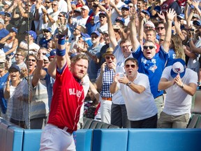 Toronto Blue Jays' Josh Donaldson takes a curtain call after his third home run in their American League MLB baseball game against the Minnesota Twins in Toronto on Aug. 28, 2016. (THE CANADIAN PRESS/Fred Thornhil)
