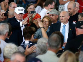 Republican presidential candidate Donald Trump greets the crowd after speaking at Joni's Roast and Ride at the Iowa State Fairgrounds, in Des Moines, Iowa, Saturday, Aug. 27, 2016. (AP Photo/Gerald Herbert)
