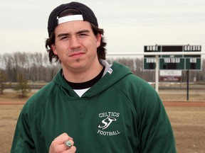 Taylor Visser, of the St. Joe's Celtics football team, poses for a picture on the St. Joe's Catholic High School football field, with his Mighty Peace Football League Championship ring in sight, on Thursday April 17, 2014 in Grande Prairie, Alberta. FILE PHOTO