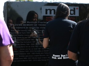 Family and friends of Stephan Sheraide Anderson, killed in an impaired driving collision in July 2011, wait to touch his name on the Manitoba Memorial Monument in remembrance of impaired driving victims following a ceremony at Glen Eden Funeral Home and Cemetery in West St. Paul, Man., on Sun., Aug. 28, 2016. (Kevin King/Winnipeg Sun/Postmedia Network)