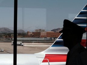 A pilot walks through the Phoenix airport on May 24, 2016 in Phoenix, Arizona.   Spencer Platt/Getty Images/AFP