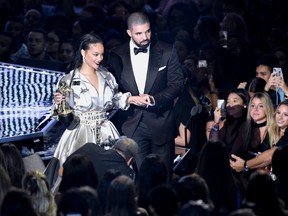 Rihanna, left, is escorted by presenter Drake after she accepted the Michael Jackson Video Vanguard Award at the MTV Video Music Awards at Madison Square Garden on Sunday, Aug. 28, 2016, in New York. (Chris Pizzello/Invision/AP)