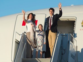 Prime Minister Justin Trudeau, his wife Sophie Gregoire, and daughter Ella-Grace wave as they board a government plane in Ottawa, on Aug. 29, 2016. (THE CANADIAN PRESS/Adrian Wyld)