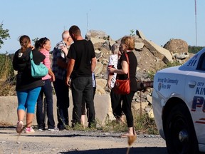 Family members of a suspected drowning victim gather at a quarry in Kingston east Monday. Ian MacAlpine/The Whig-Standard