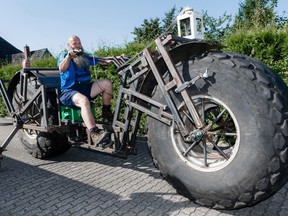 In this photo taken Saturday, Aug. 27, 2016 Frank Dose for the first time rides his self made bicycle in Rade, Germany. With giant tires from an industrial fertilizer spreader and scrap steel, a Dose has built a bike weighing 940 kilograms (2,072 pound) that he plans to pedal into the record books as the world’s heaviest rideable bicycle. (Markus Scholz/dpa via AP)