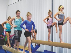 These girls from Brazeau gymnastics Club practice their routines on the beam.