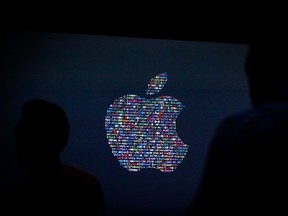This file photo taken on June 13, 2016 shows the Apple logo displayed on a screen at Apple's annual Worldwide Developers Conference presentation at the Bill Graham Civic Auditorium in San Francisco, California. Apple on August 29, 2016 sent out invitations to a "special event" on September 7 in San Francisco, where it is expected to unveil a new iPhone model. In the company's usual enigmatic style, it provided little more that the date, time and place to the invitation-only gathering set for the Bill Graham Civic Auditorium near San Francisco City Hall. (AFP PHOTO / GABRIELLE LURIEGABRIELLE LURIE/AFP/Getty Images)