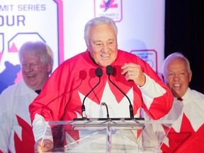 Former 1972 team Canada member Phil Esposito talks at a press conference in Montreal Tuesday, February 9, 2016 (behind are teammates Pat Stapleton (left) and Yvan Cournoyer) to announce the '72 Summit Series Tour. (John Kenney/Postmedia Network)