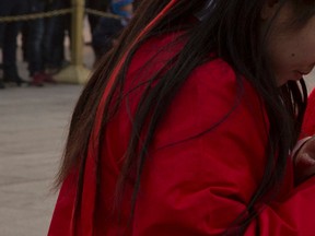 A Chinese woman in a red jacket visits Tiananmen Square in Beijing in this Dec. 19, 2015 file photo. (AP Photo/Ng Han Guan)