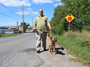Samantha Reed/The Intelligencer
Frank Rockett, executive director for the Quinte Humane Society, walks down Avonlough Road Monday afternoon with an 18-month-old dog named Rex, who is up for adoption. Rockett is encouraging everyone to come out to the Wiggle Waggle Walkathon and Run in September. The event raises funds for the operation of the shelter.