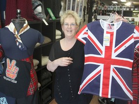 Denise Williams, an employee at The British Isles Shoppe in Kingston, shows some of the merchandise the store stocks for ex-pats form England, Scotland, Ireland, Northern Ireland and Wales. (Michael Lea/The Whig-Standard)