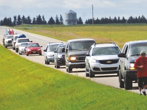 Youth participating in the Keepers of our Language Run, with a caravan of vehicles behind them, jog Aug. 7 along the side of Highway 23 north of Vulcan. The run started Aug. 6 on the Kainai Nation in Standoff and ended Aug. 7 at the Blackfoot Crossing Historical Park on the Siksika Nation.