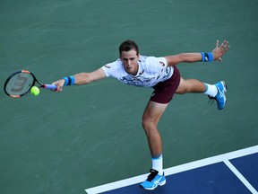 Vasek Pospisil of Canada serves to Jozef Kovalik of Slovakia during his first round Men's Singles match on Day One of the 2016 US Open at the USTA Billie Jean King National Tennis Center on August 29, 2016 in the Flushing neighborhood of the Queens borough of New York City.  (Mike Hewitt/Getty Images)
