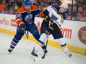 Jay Bouwmeester, shown here battling Ryan Hamilton for the puck in February 2018, will end his summer holiday earlier than expected when he reports to the Team Canada camp ahead of the World Cup. (Shaughn Butts)