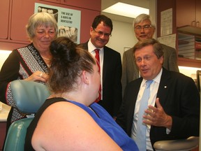 Toronto Mayor John Tory talks with a patient at a city dental clinic in Scarborough on Monday, Aug. 29, 2016 as Deputy Mayor Pam McConnell and Councillors James Pasternak and Chin Lee look on. (Terry Davidson/Toronto Sun)