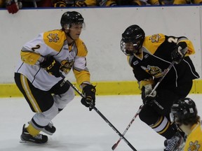 Team White defenceman Jakob Chychrun deflects the puck away from Team Black forward Zach Noble during a Sarnia Sting training camp scrimmage at Progressive Auto Sales Arena on Monday, Aug. 29, 2016 in Sarnia, Ont. Chychrun will be leaving for Arizona Coyotes' training camp in about two weeks. (Terry Bridge/Sarnia Observer)