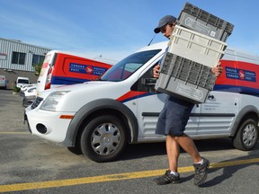 Jim Moodie/Sudbury Star
Canada Post worker Keith Thomas unloads a van at the distribution centre on Dell Street on Monday.